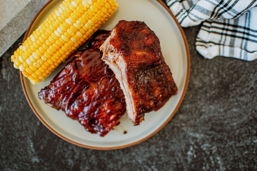 baby back ribs on a plate with corn