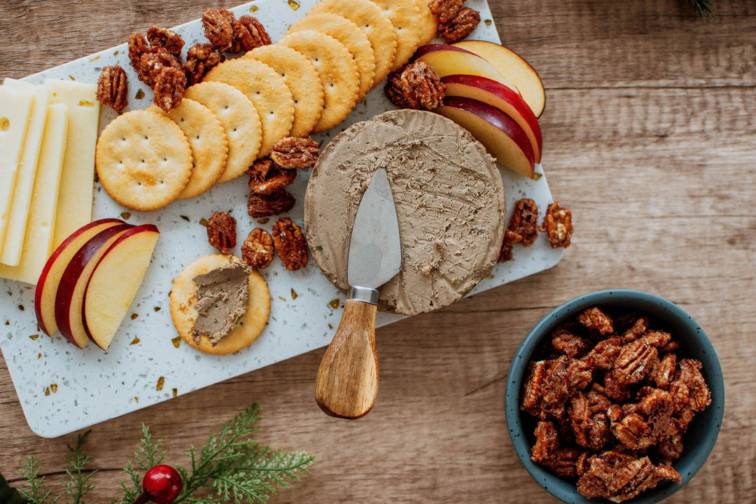 beef liver pate on a cheeseboard with crackers cheese apples and nuts