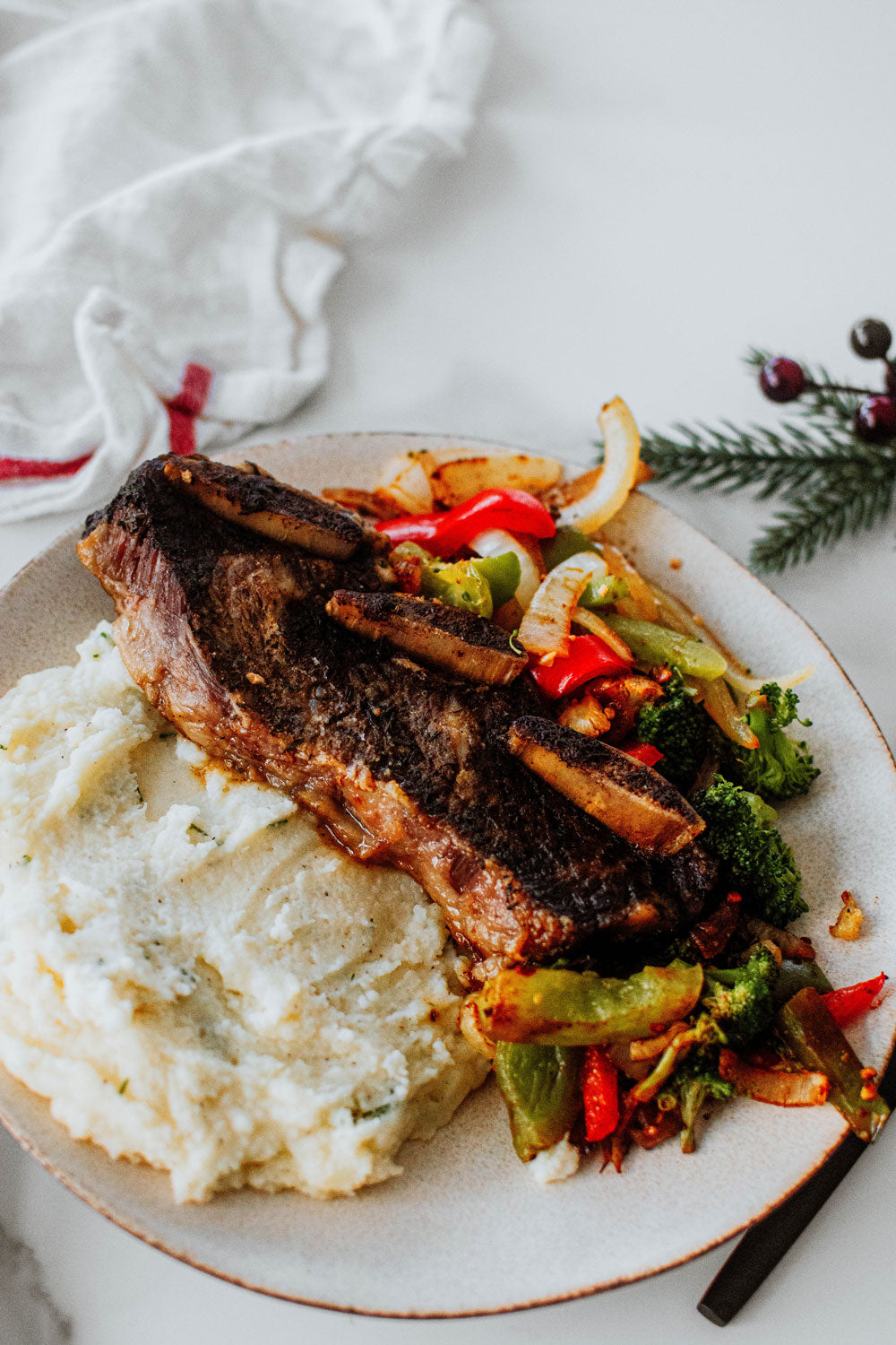 beef short ribs over mashed potatoes and veggies