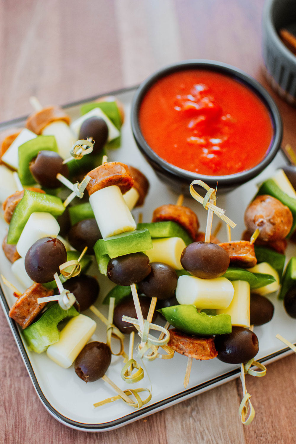 italian sausage pizza bites with marinara sauce in a bowl