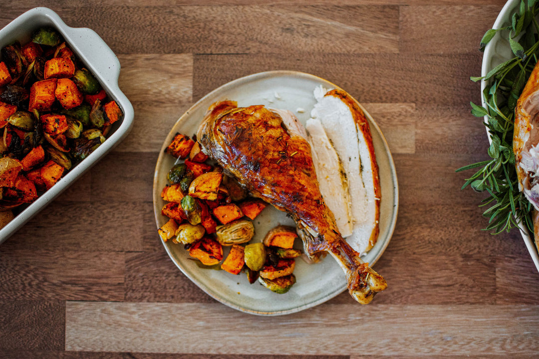 turkey leg on a plate with veggies